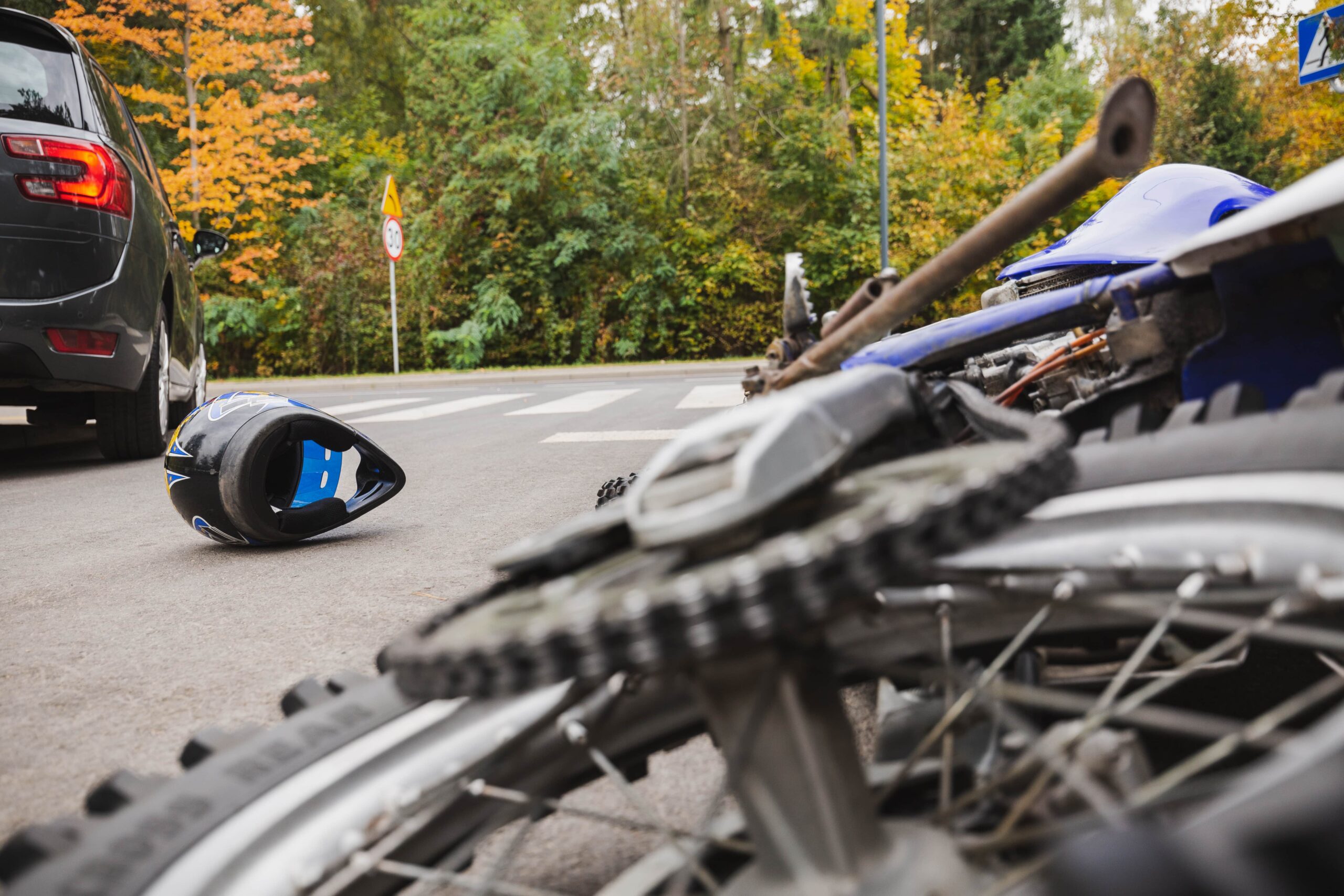 A motorcycle and car in an accident, representing the aftermath of a collision and the importance of legal assistance for motorcycle injury compensation.