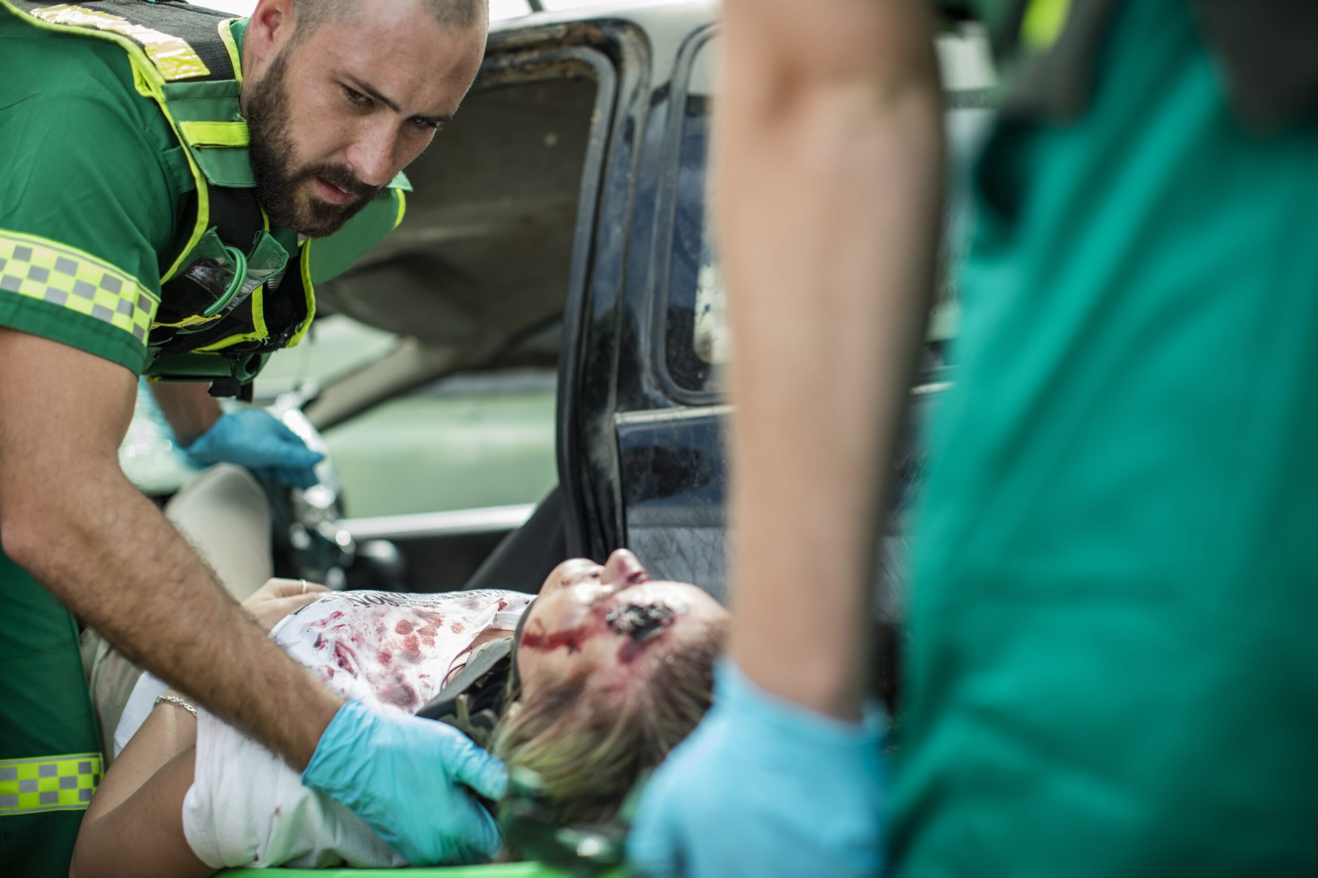 Paramedics helping truck accident victim on stretcher