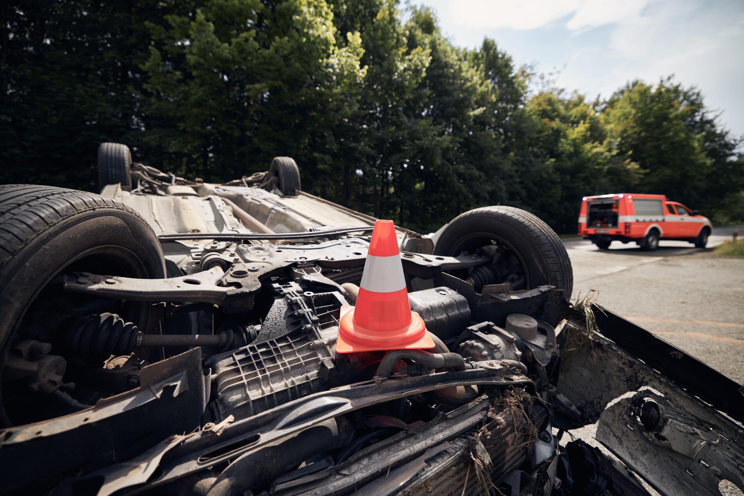 Damaged truck flipped on its roof after a traffic accident, showing the impact of a crash.