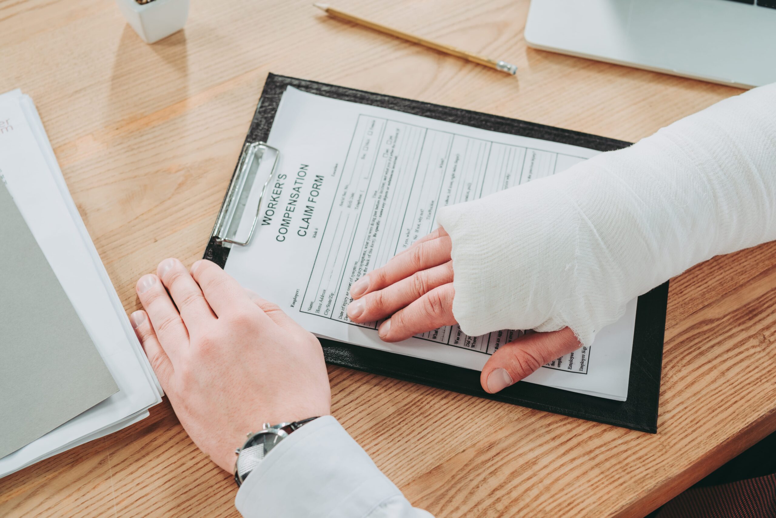 Person with a cast holding a medical document, symbolizing injury treatment in a motorcycle accident claim